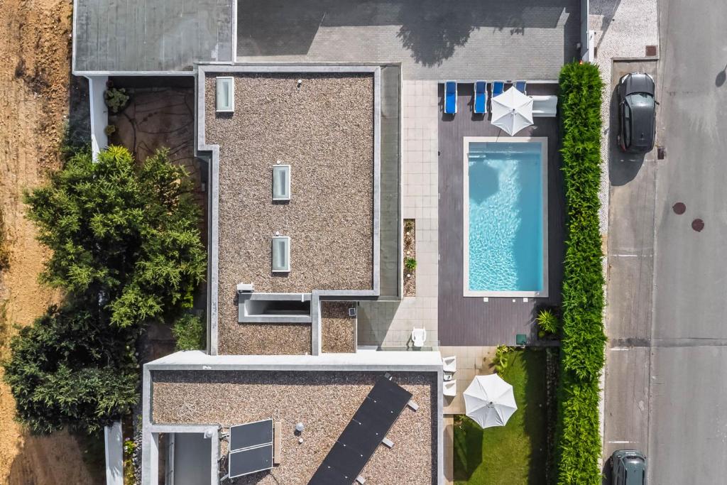 an overhead view of a building with a swimming pool at Luxury Villa- Pool, garden, total privacy in Sesimbra