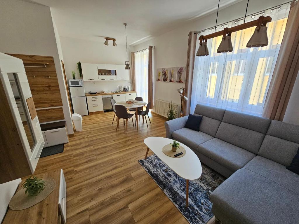 a living room with a couch and a table at GUDU apartments in Košice