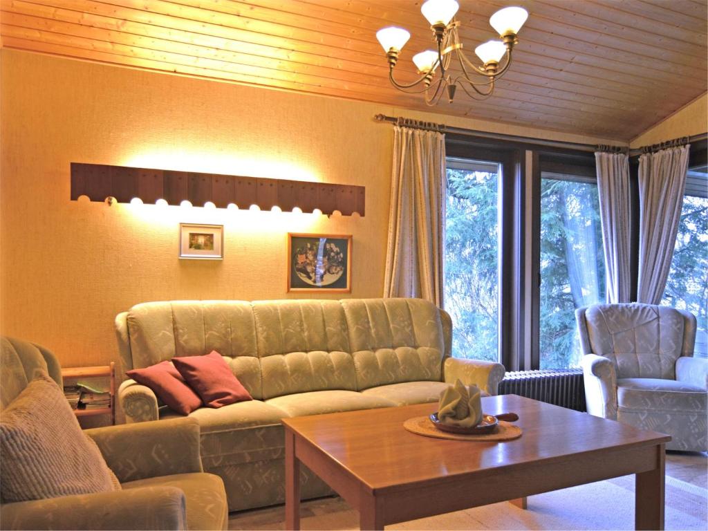 a living room with a couch and a table at Furnished Bungalow With Peaceful Neighbourhood in Meschede