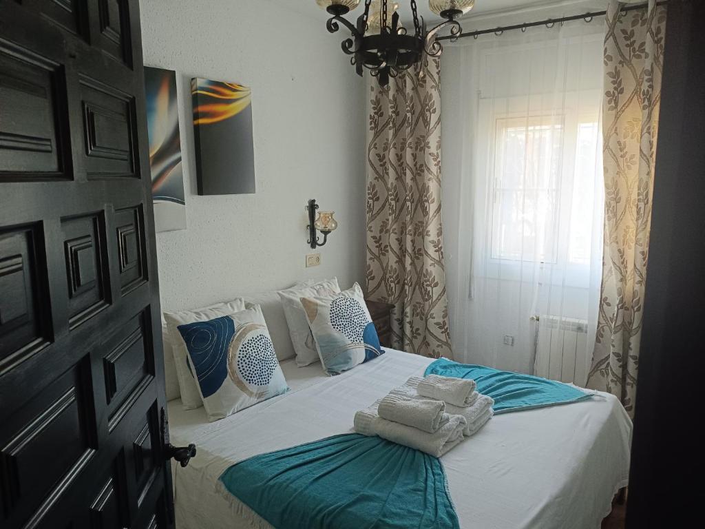 a bedroom with a bed with towels on it at Bella Terra 2 in L'Ampolla