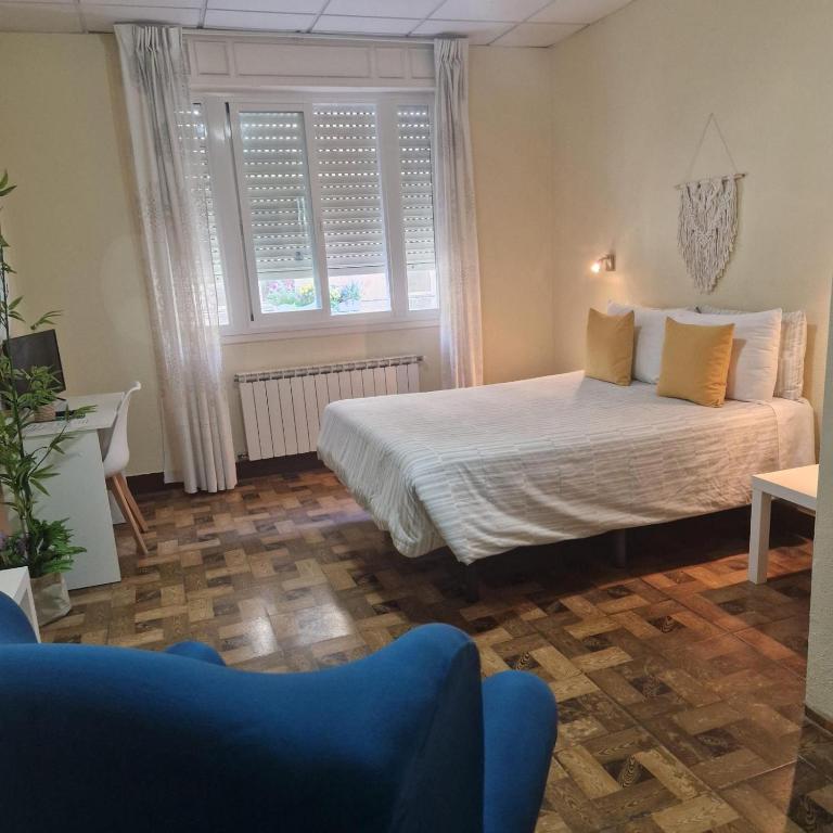 a bedroom with a bed and a window at Hostal Real in Vigo