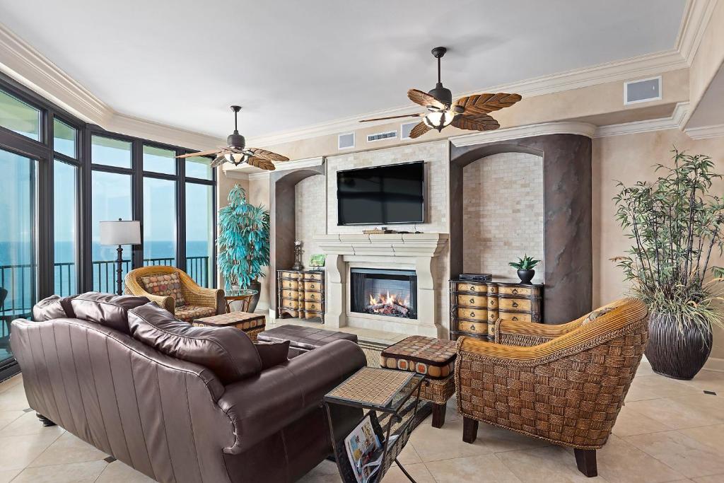 a living room with a couch and a fireplace at Phoenix West 1103 in Orange Beach