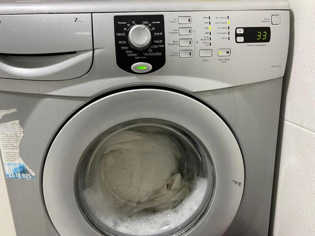 a washing machine with its door open with its door at Star Apartment Derya Izmir in Konak