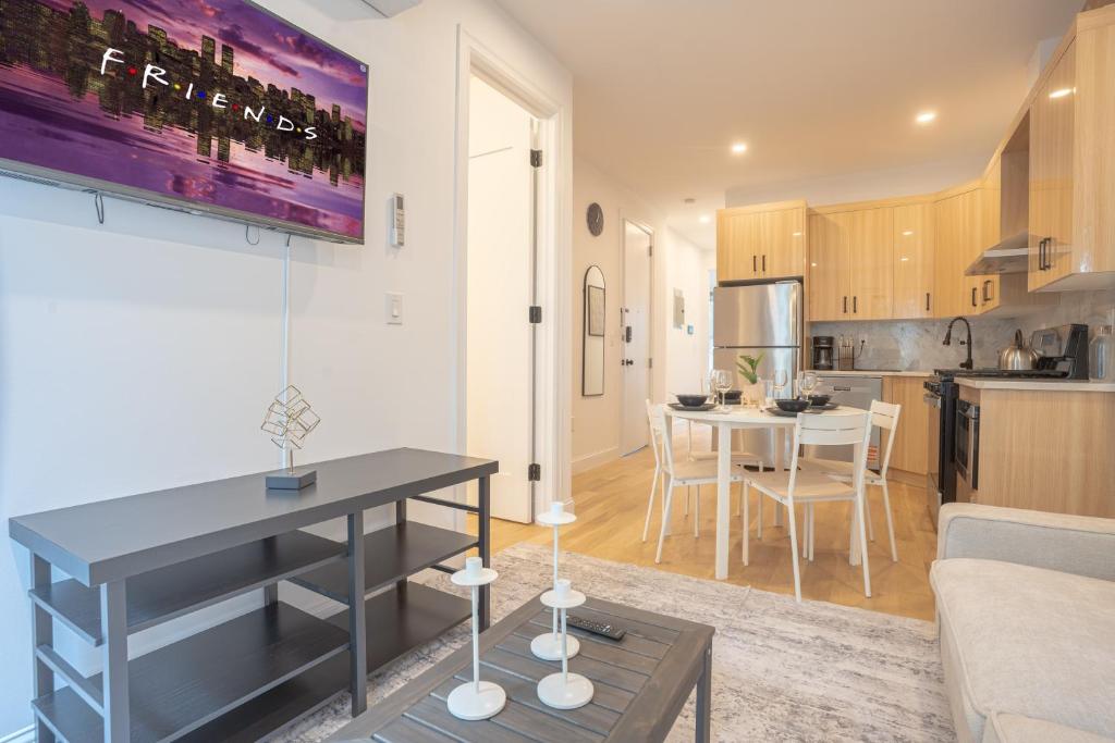 a living room and kitchen with a table and a couch at Bright & Cozy 3Bd Brooklyn Getaway in Brooklyn