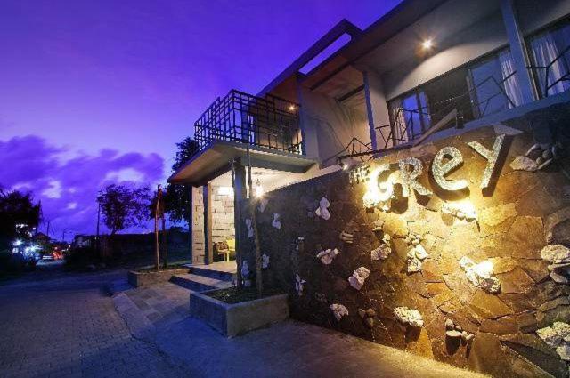 a building with graffiti on the side of it at night at The Grey Boutique Inn in Legian