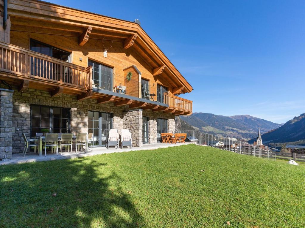 a wooden house with a lawn in front of it at Chalet in Krimml near Zillertal Ski Arena in Krimml