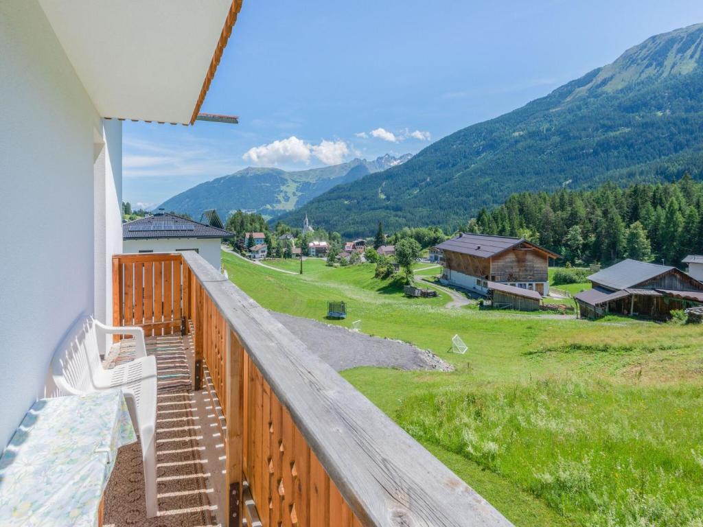 a balcony with a view of a field and mountains at Chalet in Tyrol near Ski Resort in Piller