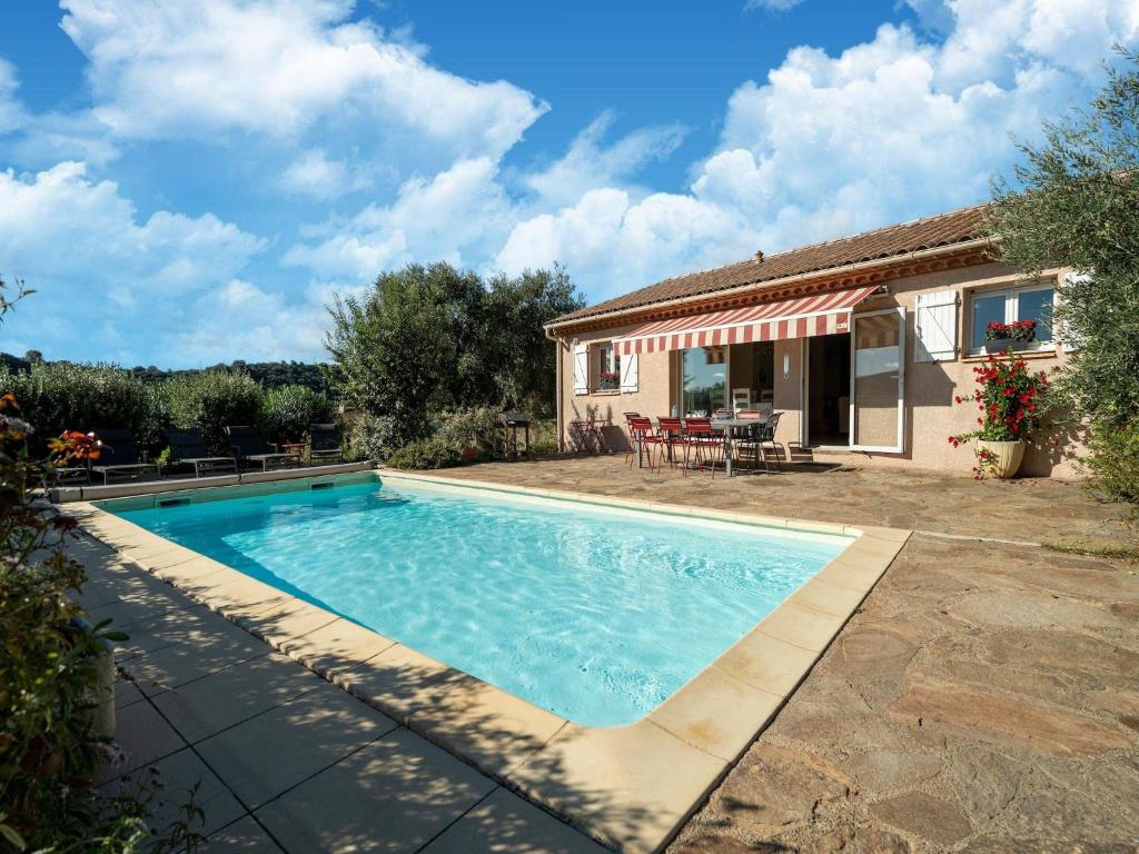 a swimming pool in front of a house at Cosy villa in Montouliers with private pool in Montouliers