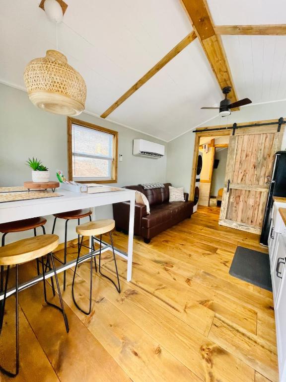 a kitchen and living room with a table and chairs at Misty Hollow Tiny Home Cottage in Robbinsville