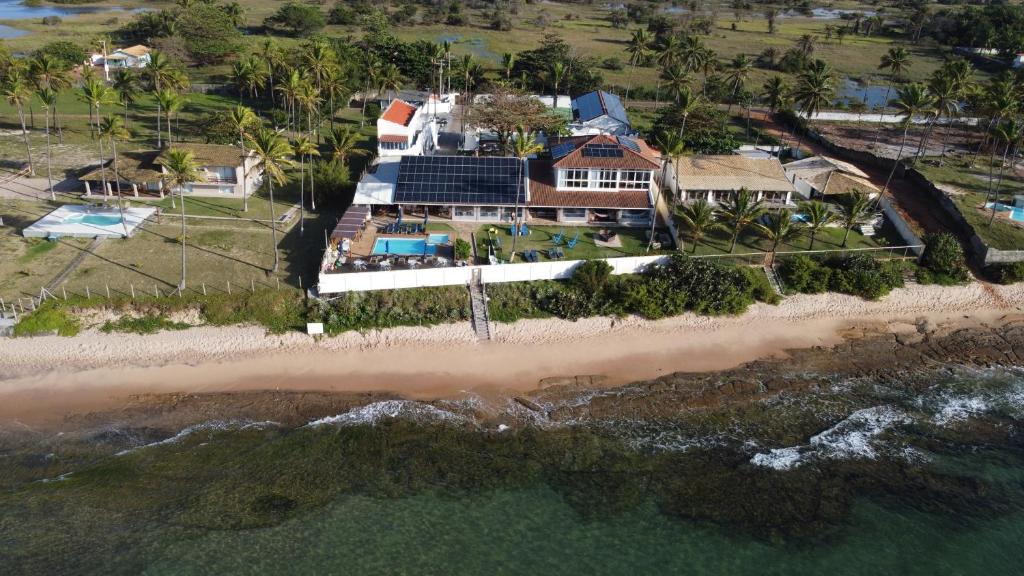an aerial view of a house on the beach at Pousada a Capela in Arembepe