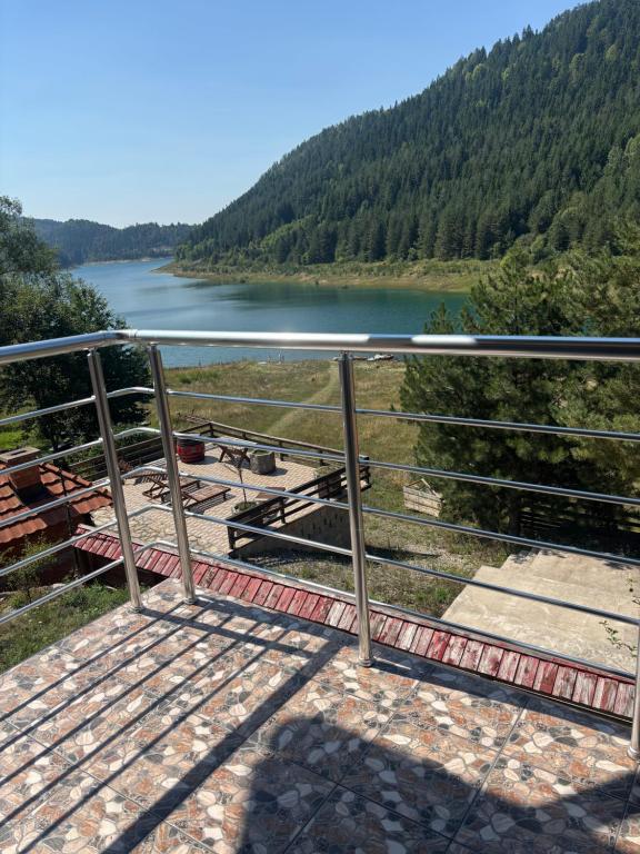 a metal railing with a view of a lake at Apartman Brod in Konjska Reka
