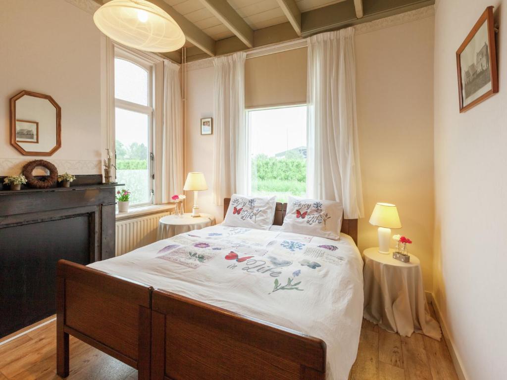 a bedroom with a bed and a large window at leisure retrete with costal nature in Wemeldinge