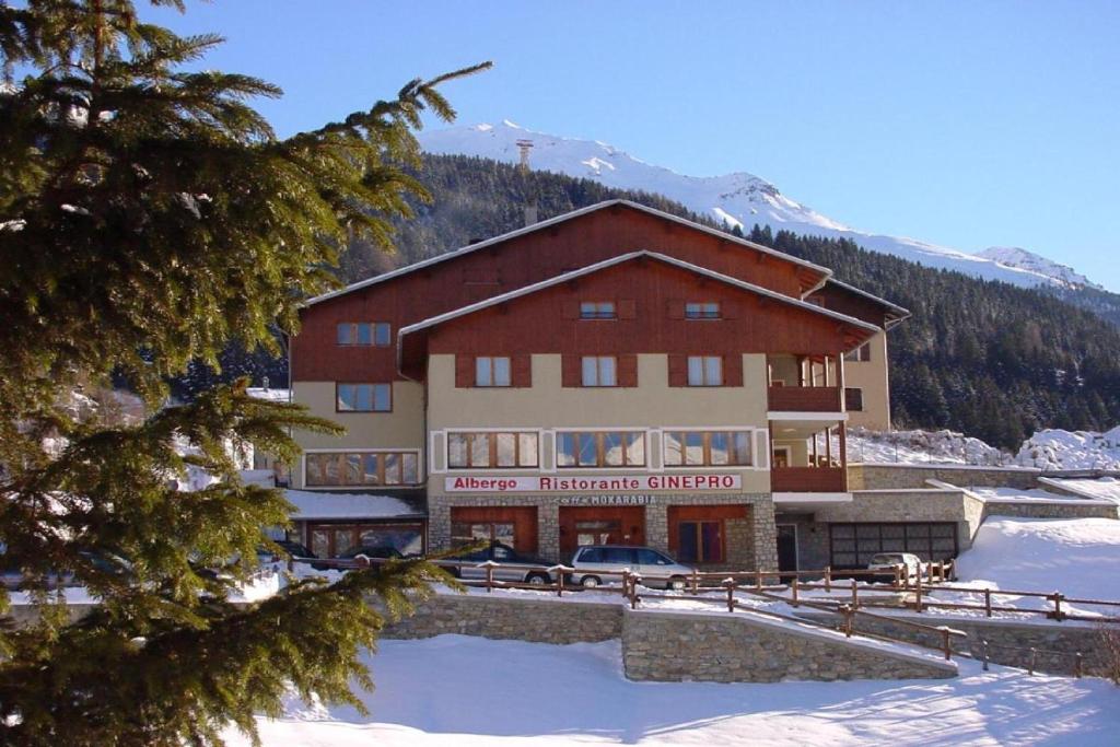 a large building with a car parked in front of it at Albergo Ristorante Ginepro in Bormio