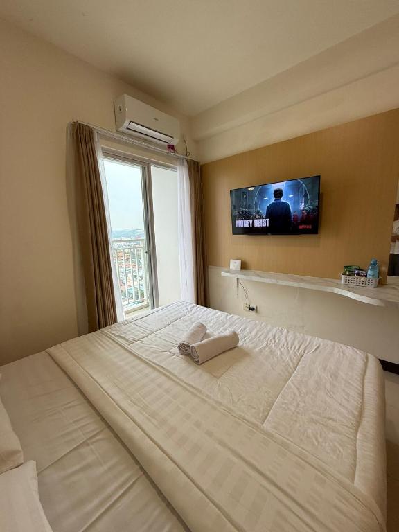 Ένα ή περισσότερα κρεβάτια σε δωμάτιο στο Citra Plaza Studio Near Nagoya Hill