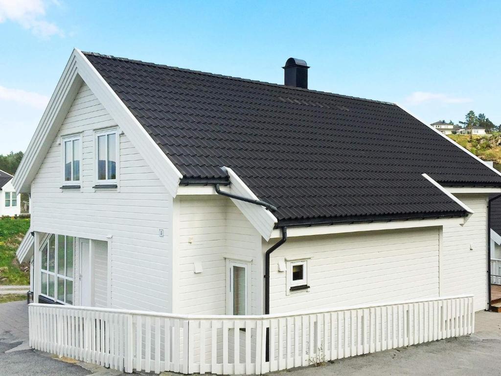 a white house with a black roof at 4 star holiday home in Auklandshamn in Vestvik