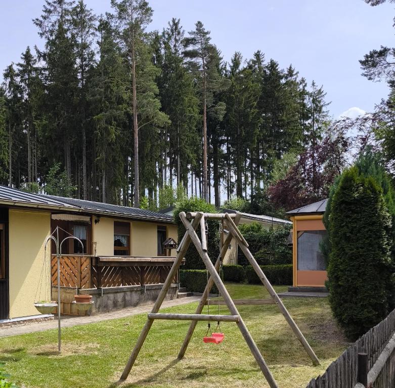 a playground in a yard next to a house at Haus Sonneneck 2 in Tanna