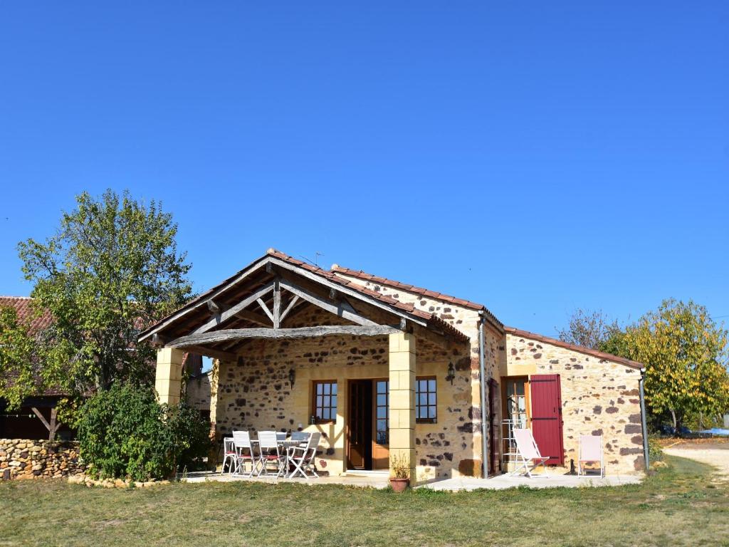 a large stone house with a red door at Tranquil Escape in Dordogne in Saint-Avit-Rivière