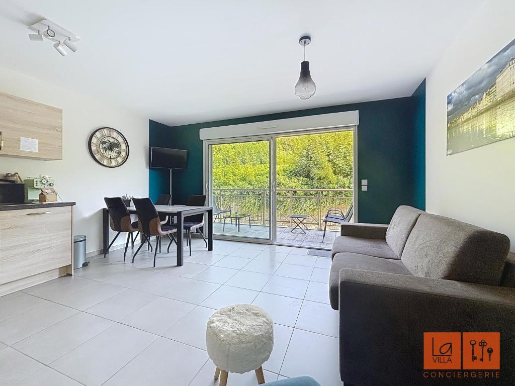 a living room with a couch and a table at La rose des vents in Wimereux