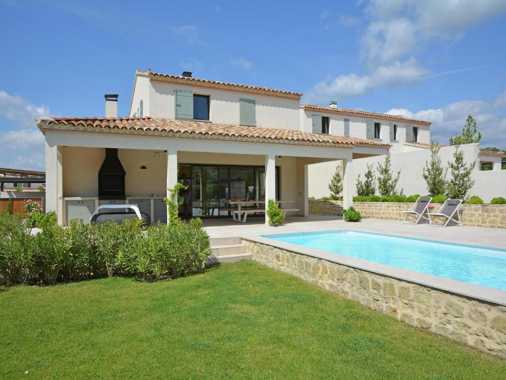 a villa with a swimming pool in front of a house at Villa in Malaucène near Mont Ventoux in Malaucène