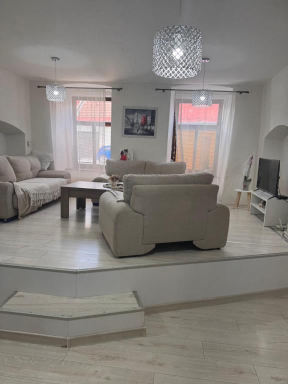 a living room with two couches and a table at Apartmán 6 in Spišské Podhradie