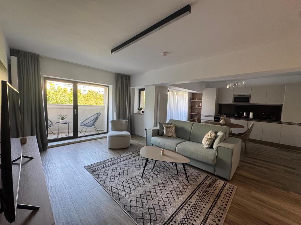 a living room with a couch and a table at Novos Luxury Apartments in Bucharest