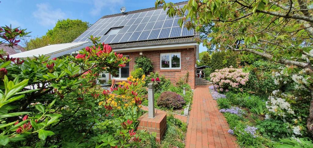 a house with solar panels on the roof at 4 Sterne Ferien Martens in Cuxhaven