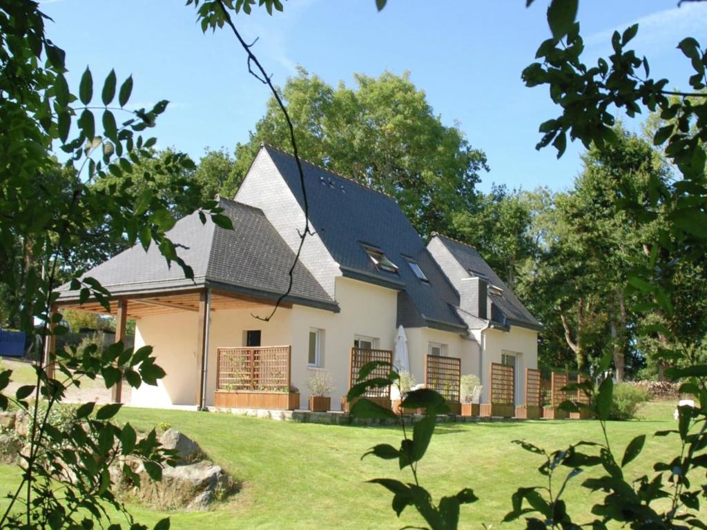 a white house with a black roof at Coastal Retreat in Plurien in Plurien