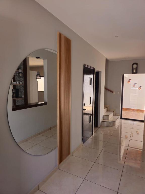 pasillo con espejo circular y escalera en San Gabriel, Santa Ana, en Santa Ana