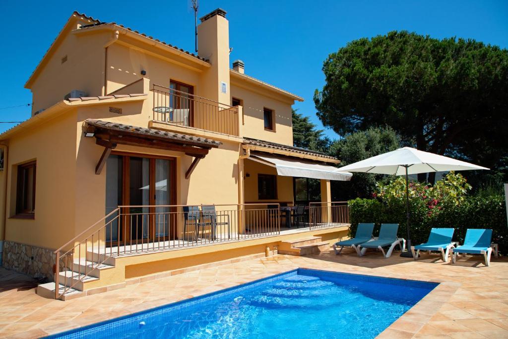 una villa con piscina frente a una casa en Villa Casa Calonge, en Calonge
