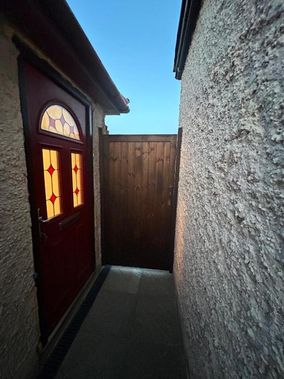 a door with a stained glass window on a building at Somewhere Nice & Cozy in Little Clacton