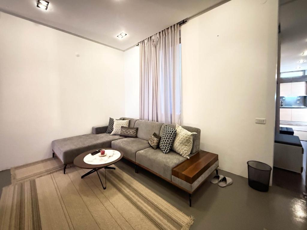a living room with a couch and a table at City Center Apartment in Belgrade