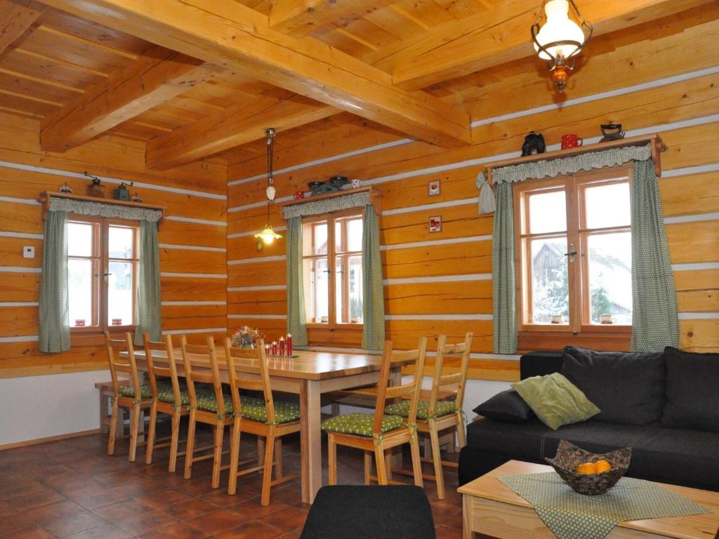 a living room with a table and chairs in a cabin at Spacious Group Retreat in Dlouhý