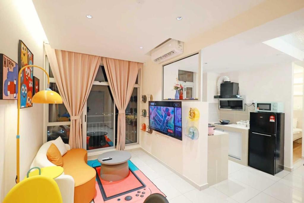 a living room with a tv and a kitchen at Midas Seri Alam Luxury Dopamine Jacuzzi in Masai