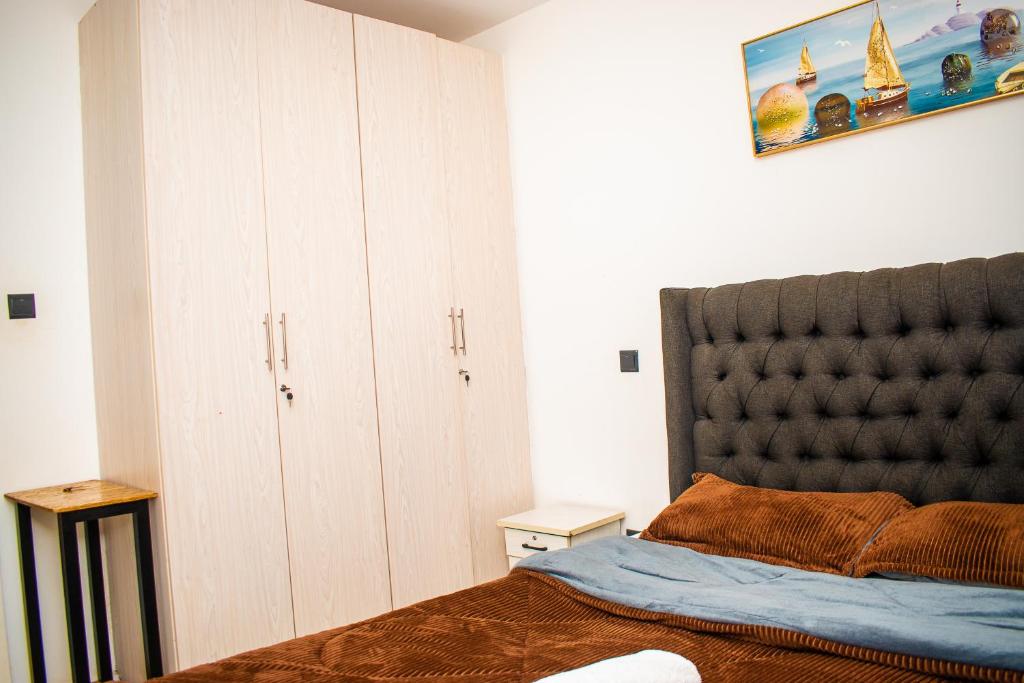 a bedroom with a bed and a large headboard at Myla homes in Kiambu