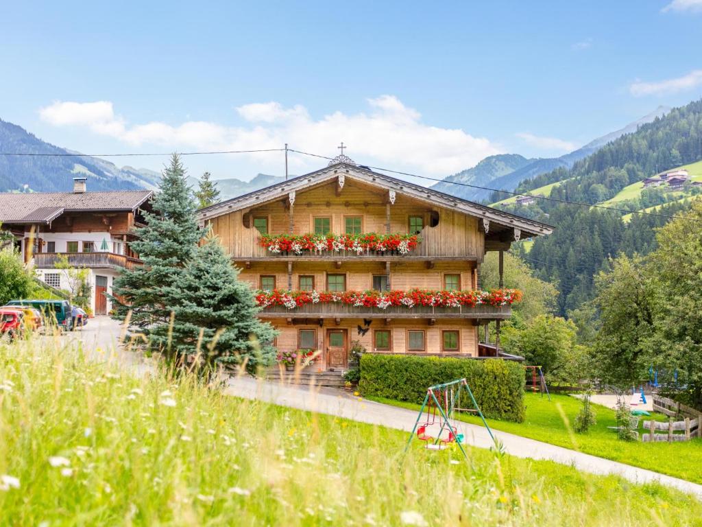 a house with flowers on the side of it at Am Bauernhof Top 1 in Alpbach