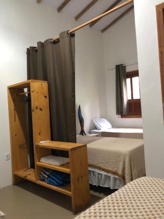 a bedroom with two twin beds and a mirror at CASA MEDNA in Trancoso