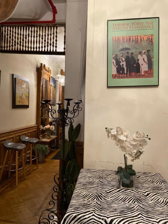 a room with a table and a poster on the wall at Harlem Brownstone in New York