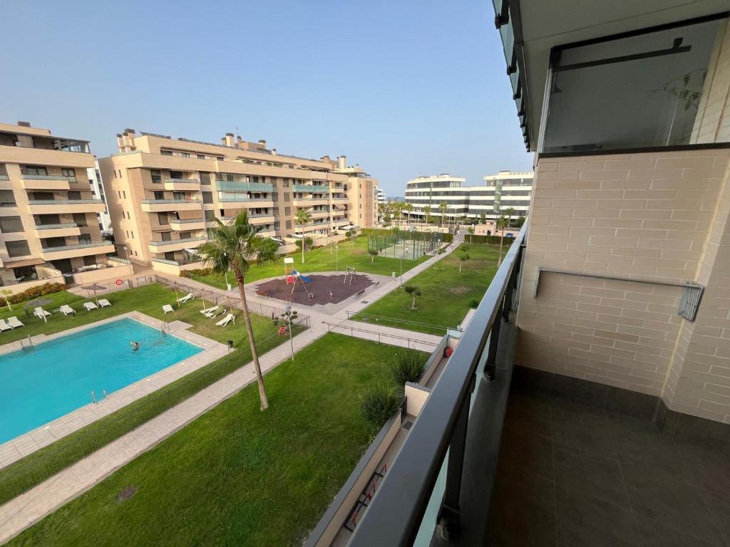 a view of a pool from the balcony of a building at Los Alamos Breeze - Modern Beach Apartment in Torremolinos