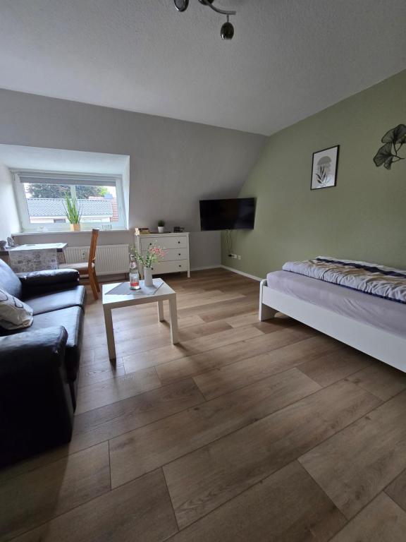 a living room with a bed and a couch at M&D ISKA Vermietung w4 in Heide
