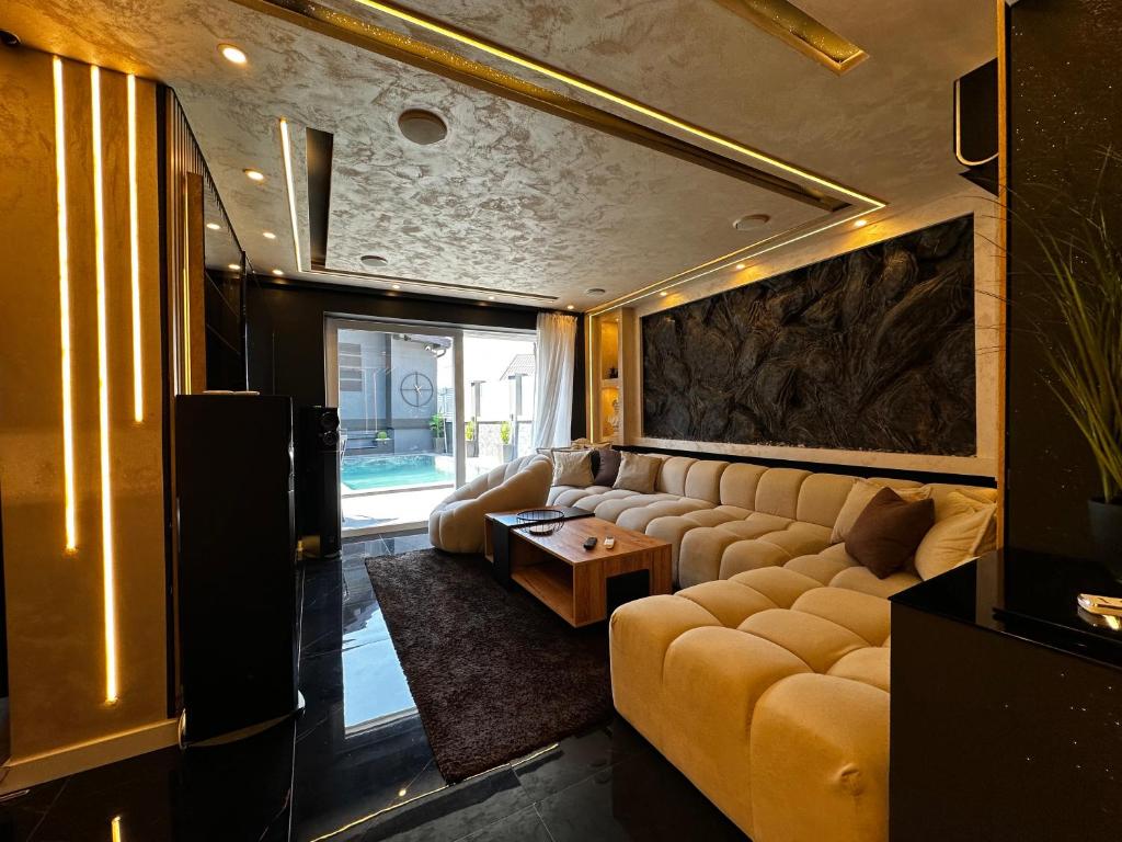 a living room with a couch and a table at Vila CITY by BEN&CO in Sarajevo