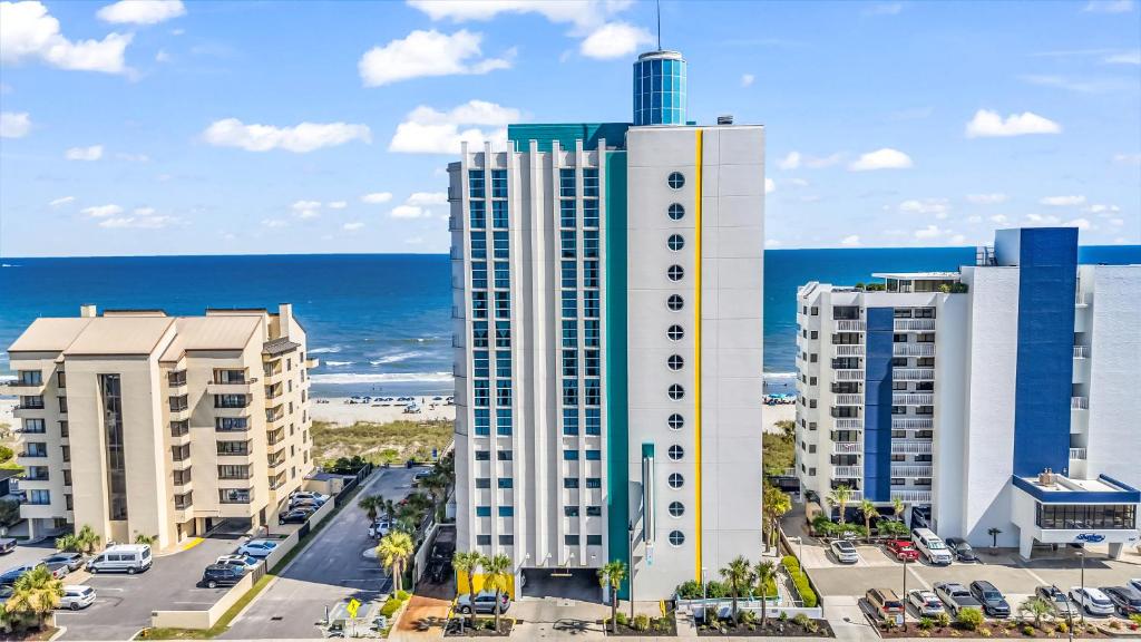 an aerial view of a building with the ocean in the background at Seaside Resort in Myrtle Beach