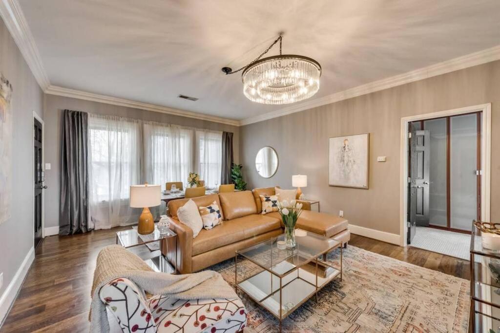 a living room with a couch and a table at Swiss Avenue Luxury 1br Condo Historic Dallas in Dallas