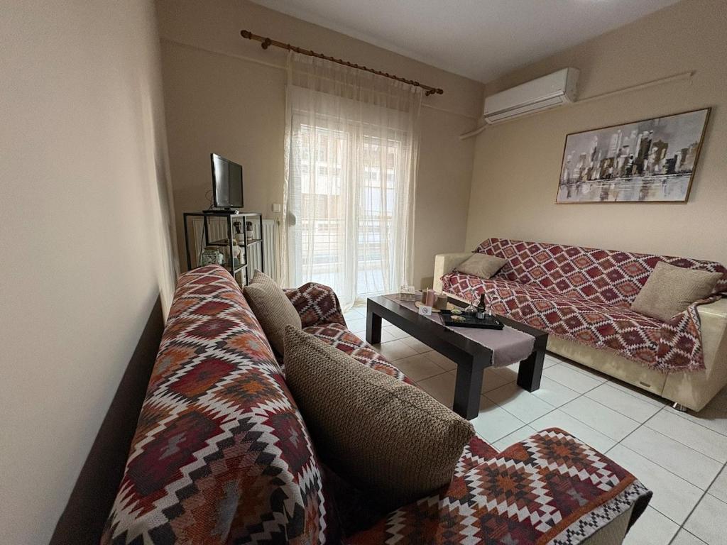 a living room with a couch and a table at Cosy Retreat in Komotini