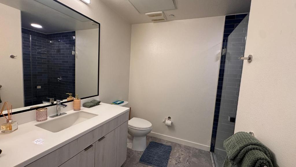 a bathroom with a sink and a toilet and a shower at Luxury Walk of Fame Studio in Los Angeles