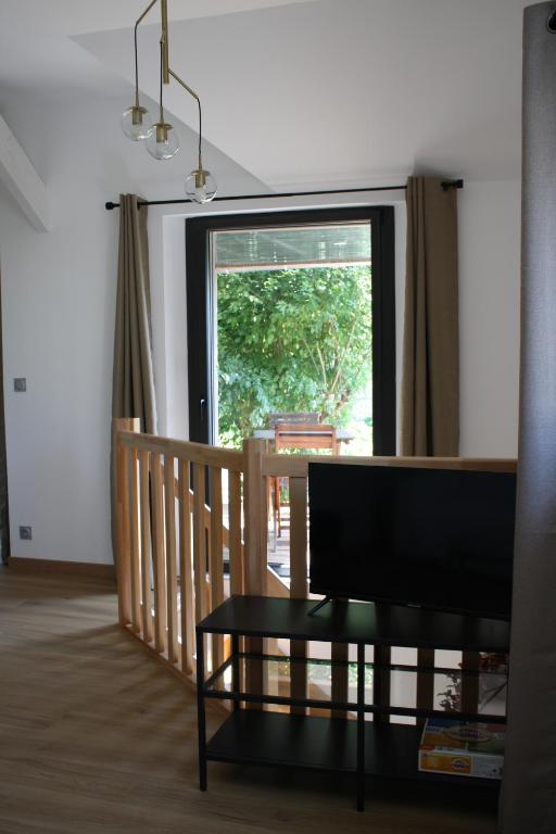 a living room with a table and a window at La boutique des Roches in Mondeville