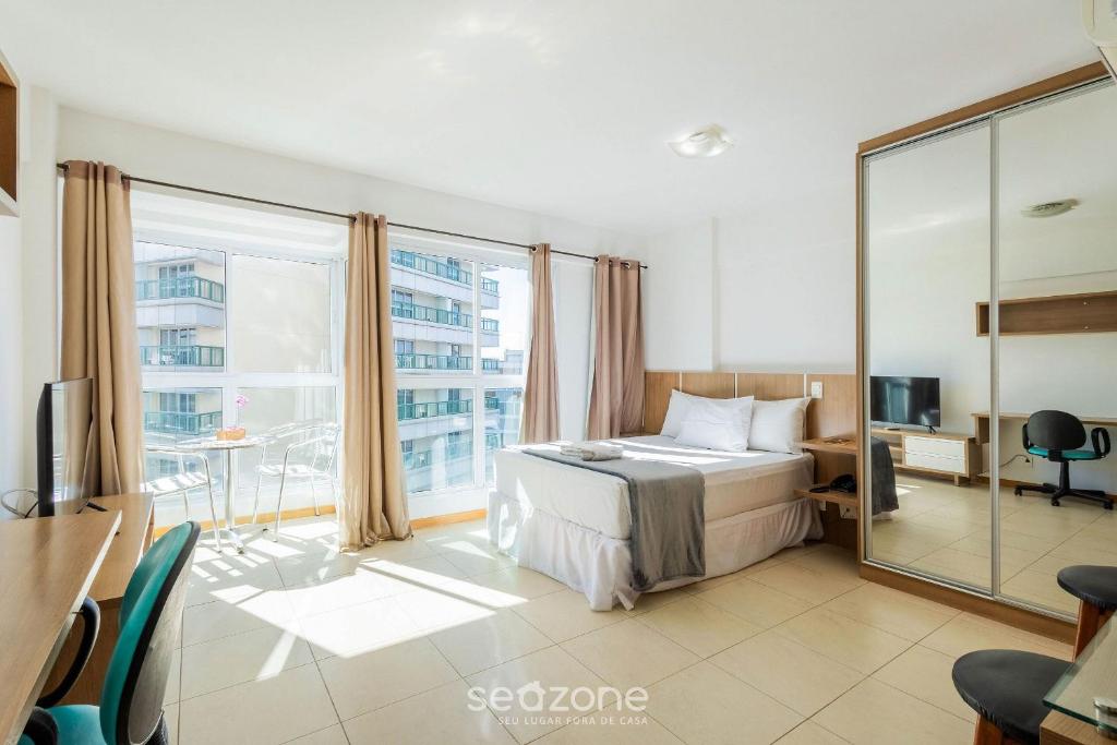 a hotel room with a bed and a large window at Studio em cond. c/ Academia, Asa Norte SMZ407 in Brasilia