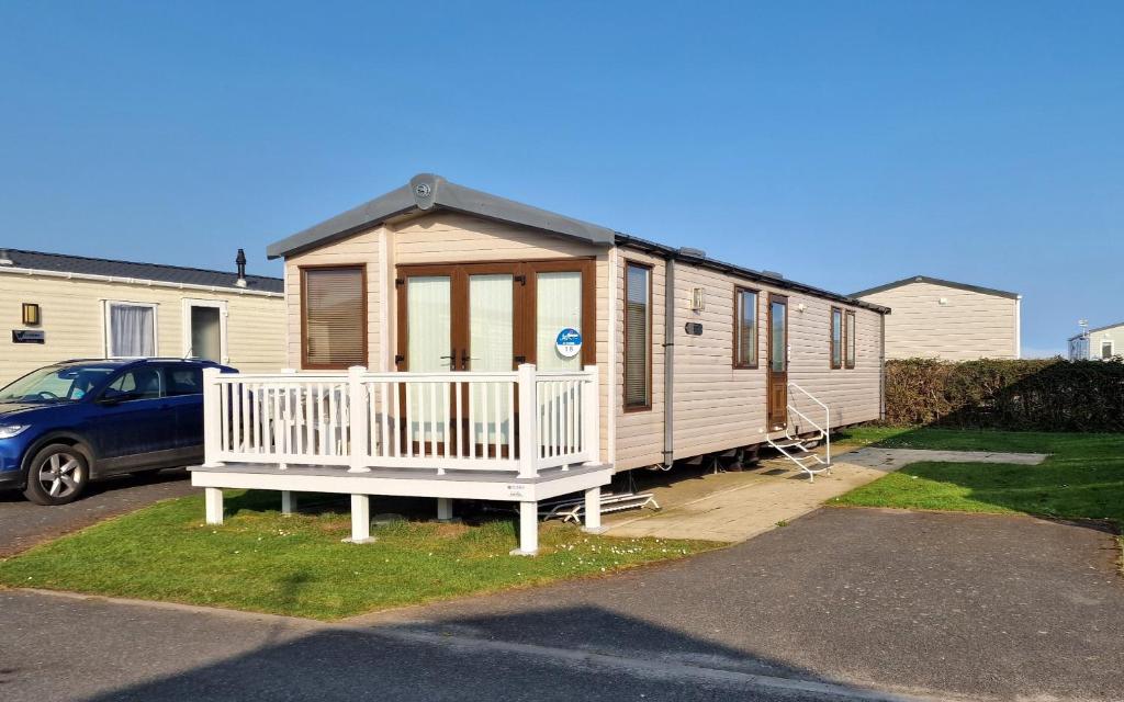 a tiny house is parked in a driveway at Megerlilly Family Hideaway, Church Farm in Pagham