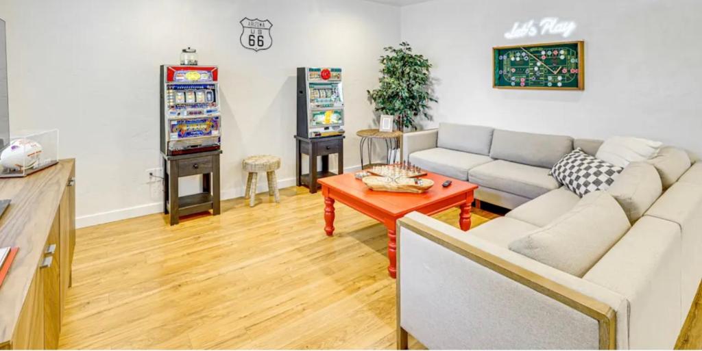 a living room with a couch and a video game at Game Night Downtown -BSU -Slots - Pool - 100 games in Boise