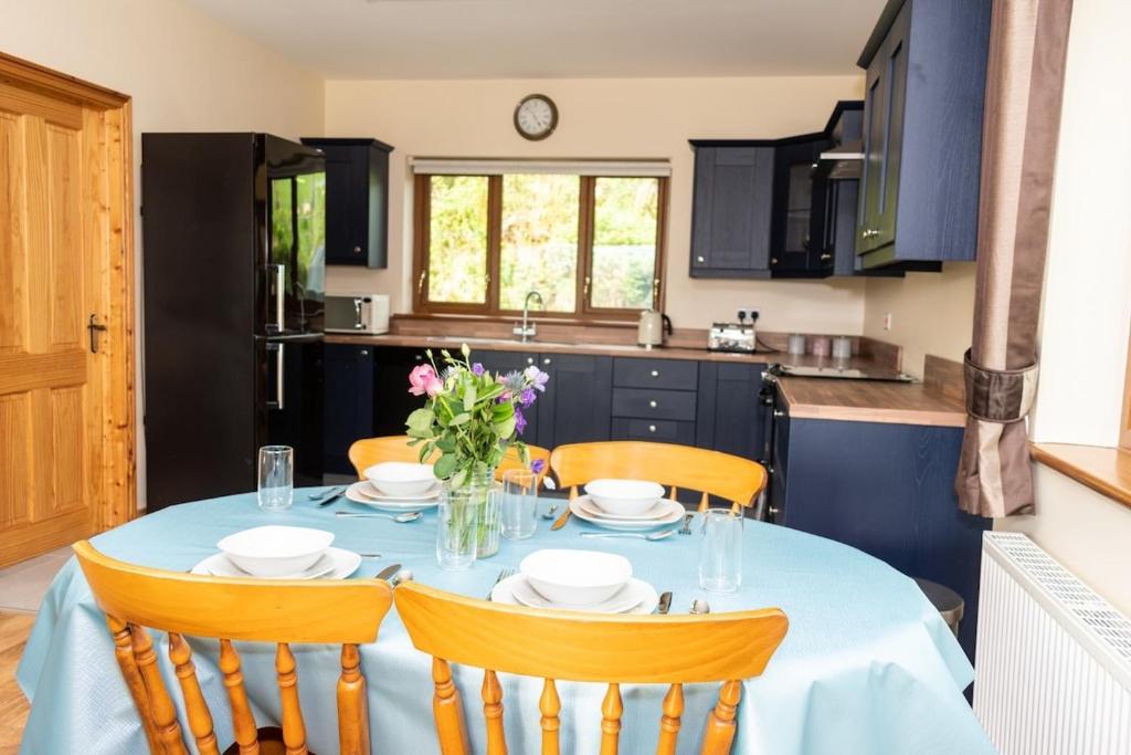 a kitchen with a table with chairs and a tableablish at The Cornerstone in Maghera