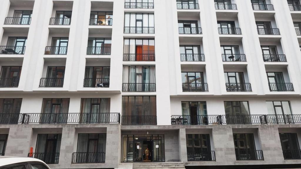 a large white building with windows and balconies at ALVINA Complex Tsaghkadzor in Tsaghkadzor